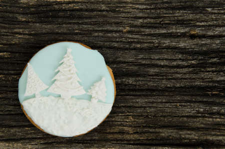 Christmas ball iced gingerbread cookies on a old textured wood background. Home made. Food backgrund.の写真素材