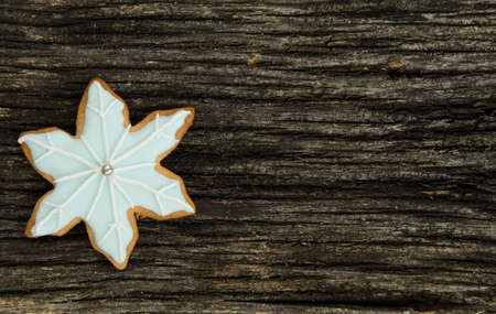 Christmas snowflake iced gingerbread cookies on a old textured wood background. Home made. Food...