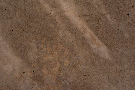 Texture of concrete with a shadows and spots. Close-up. Inclusions of sand of different colors. Old...