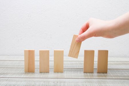 hand put wooden dominoes in a row white background, frontal feed, rectangles for your inscription 6...