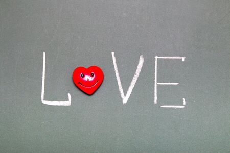 inscription love on a green chalk board, heart instead of the letter o, valentines day conceptの写真素材