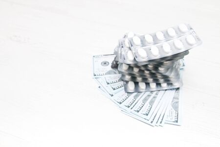 pills on 100 dollar bills, pharmaceutical business concept,copy space top viewの写真素材
