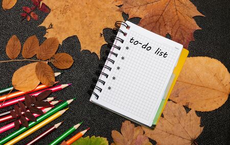 notebook color pencils gry auturm sheets on a black backgoundの写真素材