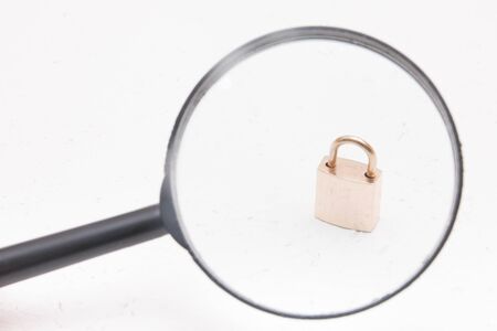 golden castle under a magnifying glass, white background, copy spaceの写真素材
