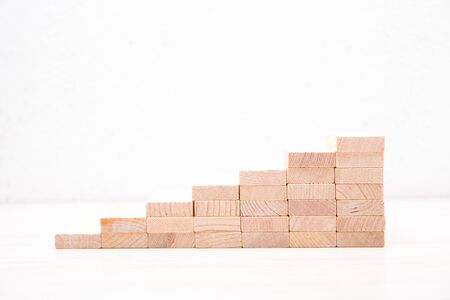wooden domino stairs side view on white backgroundの写真素材