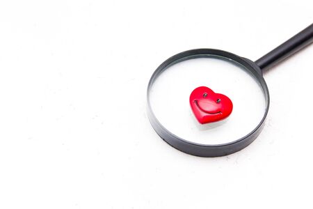 seek love, heart and magnifier, dating concept, valentines day greetings, pink backgroundの写真素材