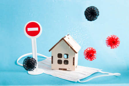 wooden house behind wet glass, blue background, quarantine, isolation, health protection, protective...