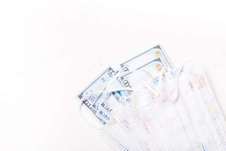 children's medical masks with a picture, protection against coronavirus, a stack of dollar bills,...
