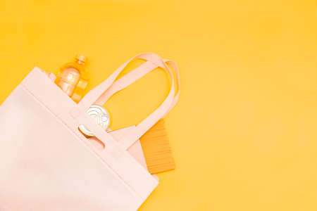 food donation, cereal, pasta, canned oil in a fabric bag, yellow background, copy space, top view, safe contactless delivery concept, volunteering and help with self-isolationの写真素材