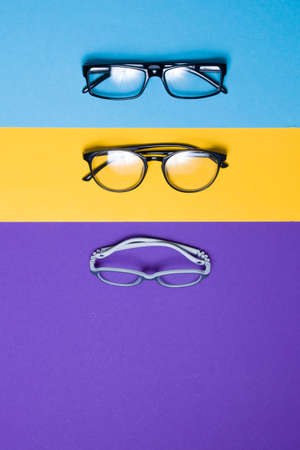 several different glasses on a colorful background, top view, buying glasses, a store of glasses and frames for glasses, children's glasses and glasses for adultsの写真素材