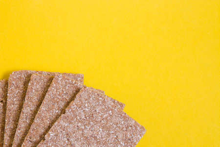 rye bread crisps on a yellow background copy space, healthy eating conceptの写真素材