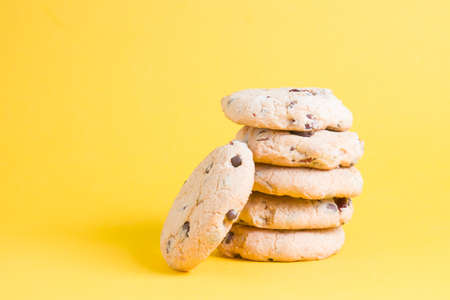 cookies on a yellow background, cookie chip with pieces of chocolate and lingonberry? copy space