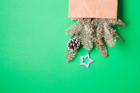 bouquet decorated with pine cones and Christmas toys, green background copy spaceの写真素材