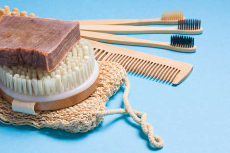 bamboo toothbrushes, wooden comb, knitted washcloth, natural homemade soap and dry massage brush on...