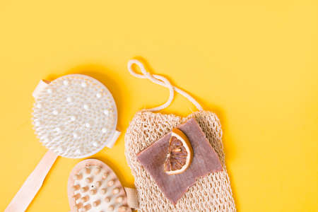 dry anti-cellulite massage brush, knitted washcloth, homemade cocoa soap, dried orange slices and a...