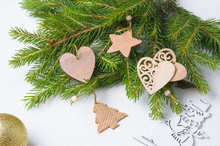 wooden eco friendly Christmas tree toys and fresh tree branches on a white background, zero waste life styleの写真素材
