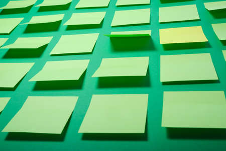 a lot of green sticky notes on a green backgroundの写真素材