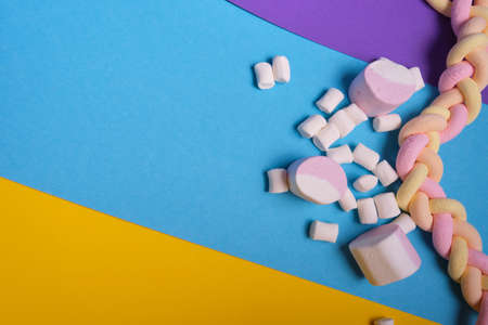 different types of marshmallows with different flavors on a bright colored background, long...