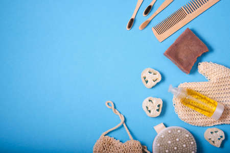 Daily hygiene items. Blue background. Natural cosmetics background with top view and copy space....