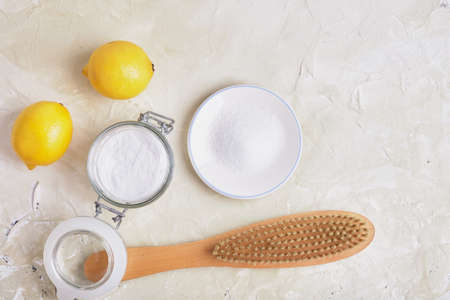 citric acid, soda, lemons and a wooden brush on a light background for eco cleaning, natural and non-toxic detergents, zero waste lifestyle conceptの写真素材