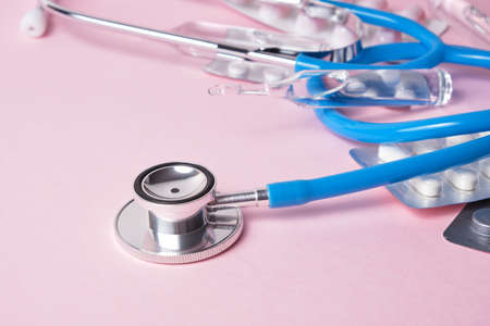Medical equipment, stethoscope, ampules and syringe on pink backgroundの写真素材