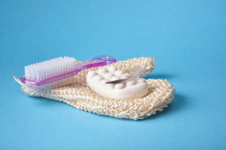 massage soap, washcloth mitten and pumice stone with pink plastic handle and pedicure brush and...