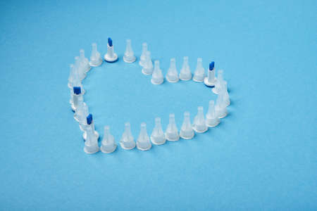 insulin needles in the form of a heart on a blue background