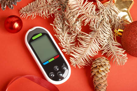 glucose meter christmas and new year decorations, diabetes and holidays concept, glucometer as a...