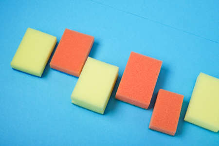 New colorful sponges for washing dishes on blue background top viewの写真素材