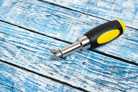 screwdriver on a blue wooden background copy space