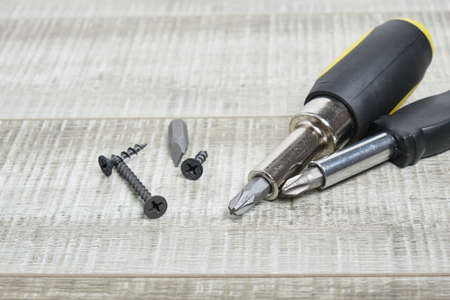 screw driver with nozzles on wooden background copy space