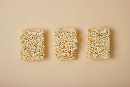 Dried instant noodles on beige background. top view copy spaceの写真素材