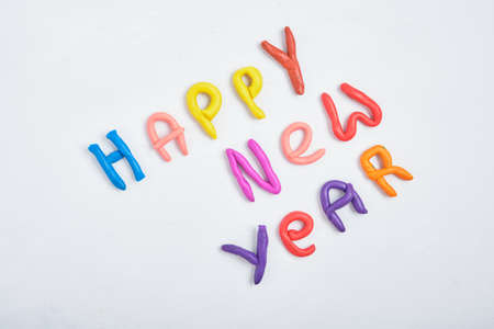inscription happy new year from plasticine on a gray background top viewの写真素材