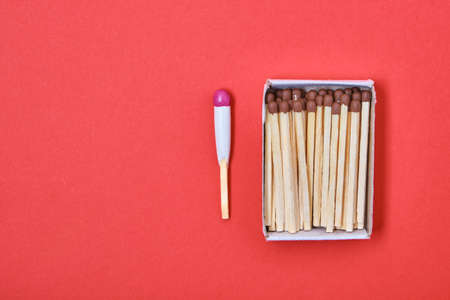 Hunting waterproof matches and paper box with simple matches on red background copy space top viewの写真素材