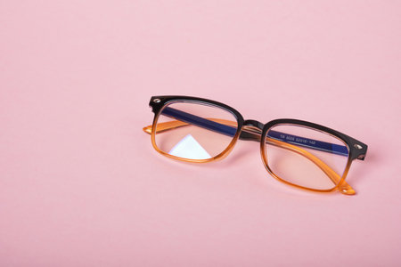glasses for working at the computer on a pink backgroundの写真素材