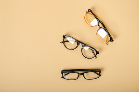 several pairs of glasses on a beige background top viewの写真素材
