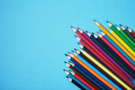 color pencils on blue background copy space top viewの写真素材