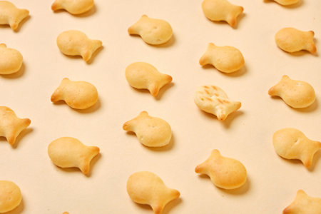 fish crackers on beige background top view