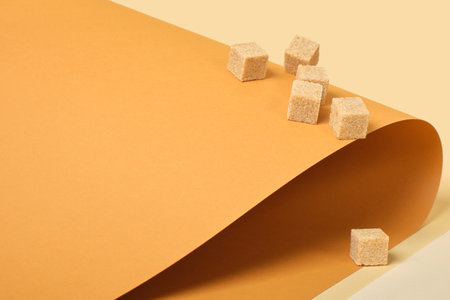 cane sugar cubes on brown background, trend color place copy, roll paper, beige backgroundの写真素材