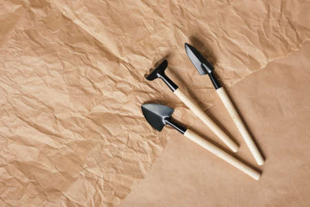 gardening set of small rakes and shovels on brown craft paper copy space top viewの写真素材
