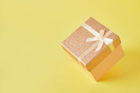 shiny pink square box on yellow background copy spaceの写真素材