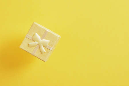 yellow square flying gift box on yellow background copy space