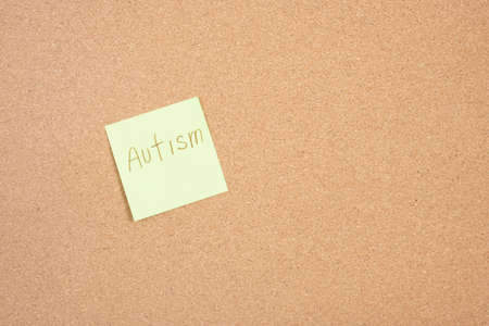 pinned sticker on corkboard, autism lettering sticker.