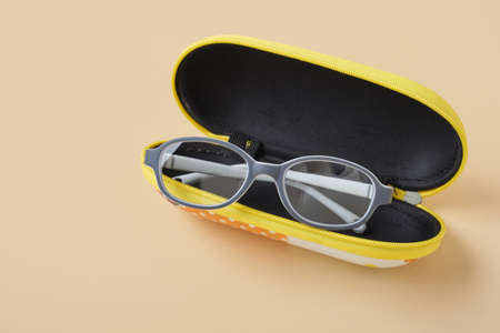children's glasses in a case, beige background, taking care of children's eye health copy spaceの写真素材