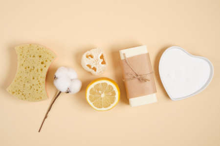 eco friendly cleaning and body care kit, lemon, soap, soda, loofah, sponge and cotton flower on...