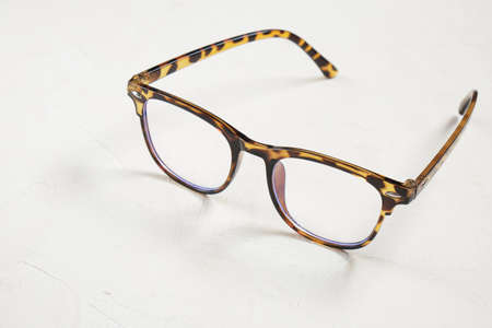 Leopard-colored eyeglass frames on beige background. copy spaceの写真素材
