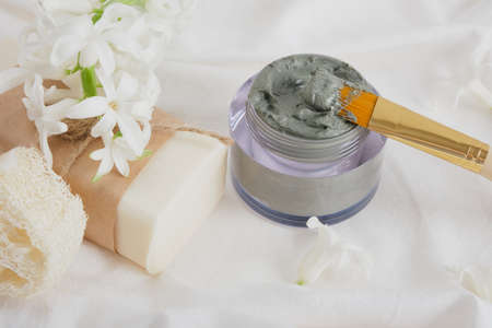 hyacinth flowers, a bar of soap and blue clay in a jar on a white cloth natural cosmetic and zero waste life style conceptの写真素材