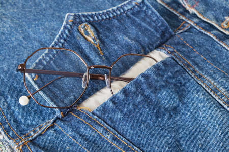 eye glasses in the pocket of a blue denim jacket, trend eyes glasses copy spaceの写真素材