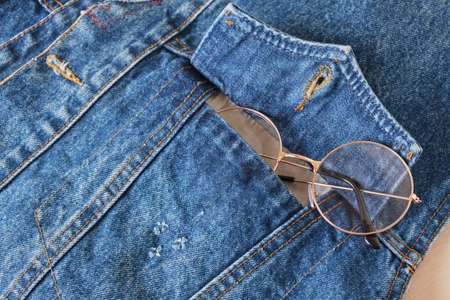 eye glasses in the pocket of a blue denim jacket, trend eyes glasses copy spaceの写真素材