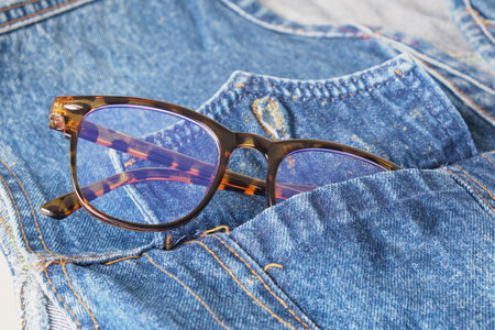 eye glasses in the pocket of a blue denim jacket, trend eyes glasses copy spaceの写真素材